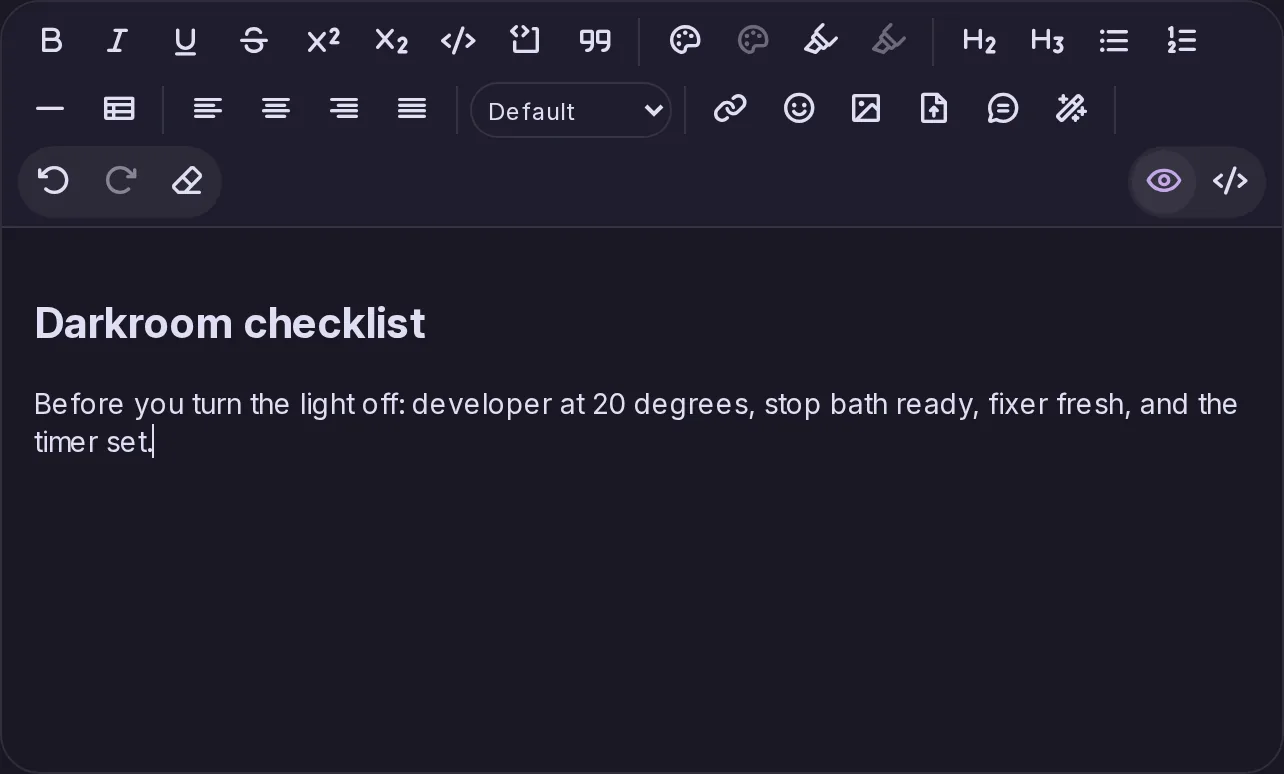 The editor for Pages: a toolbar with text styles, colours, headings, lists, tables, alignment, links, emoji, images, files and a visual or HTML switch, above a page being written.