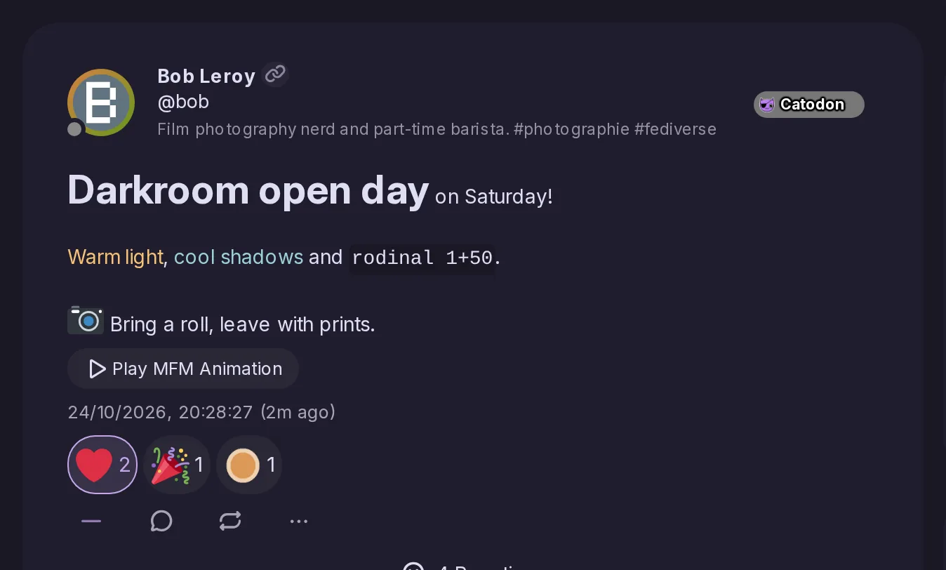 Bob's post written in MFM: a large bold title, words in two colors, inline code and an animated camera emoji, above its reactions.